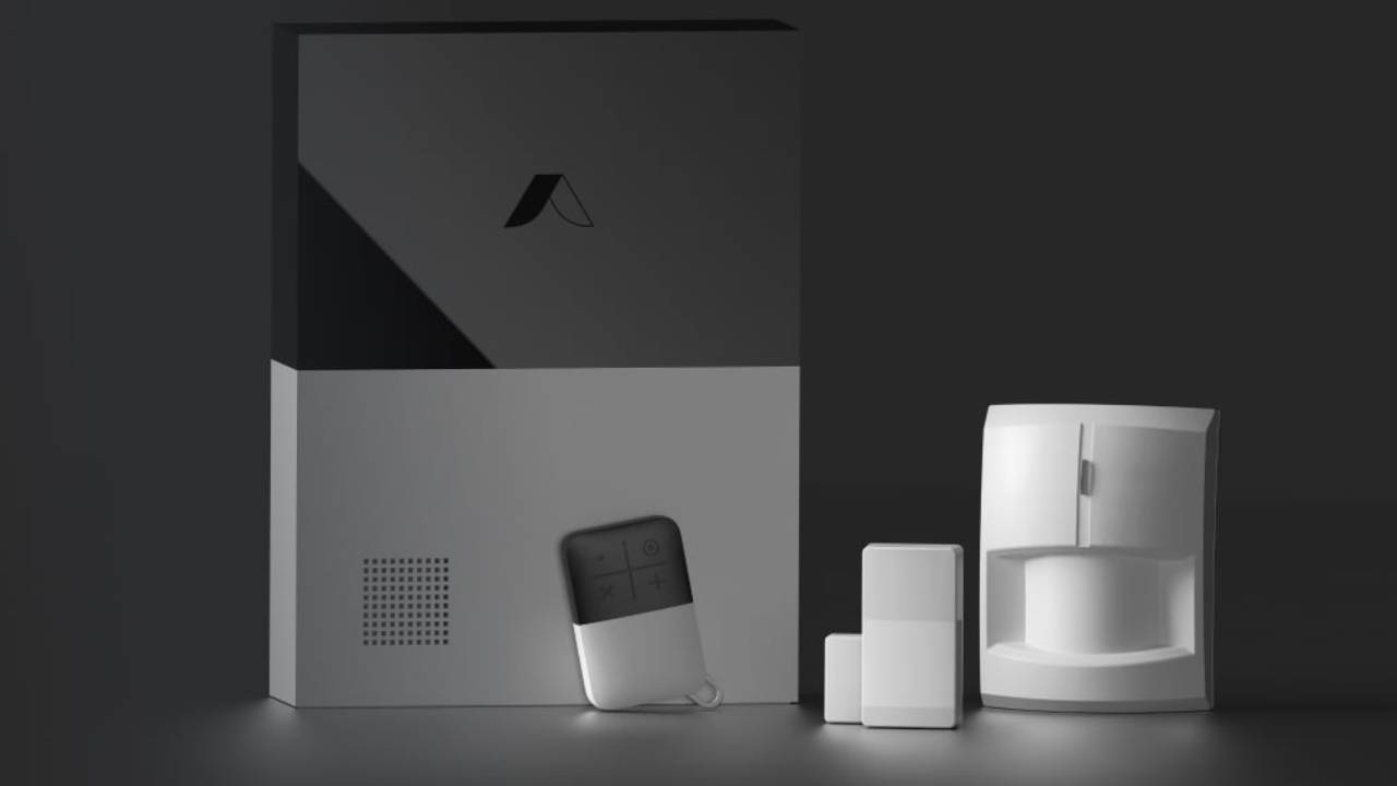 abode home security system components on black background