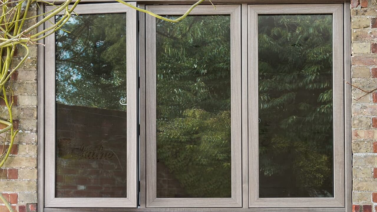 Anglian vs Everest. An Everest uPVC casement double glazing window with wood grain finish.